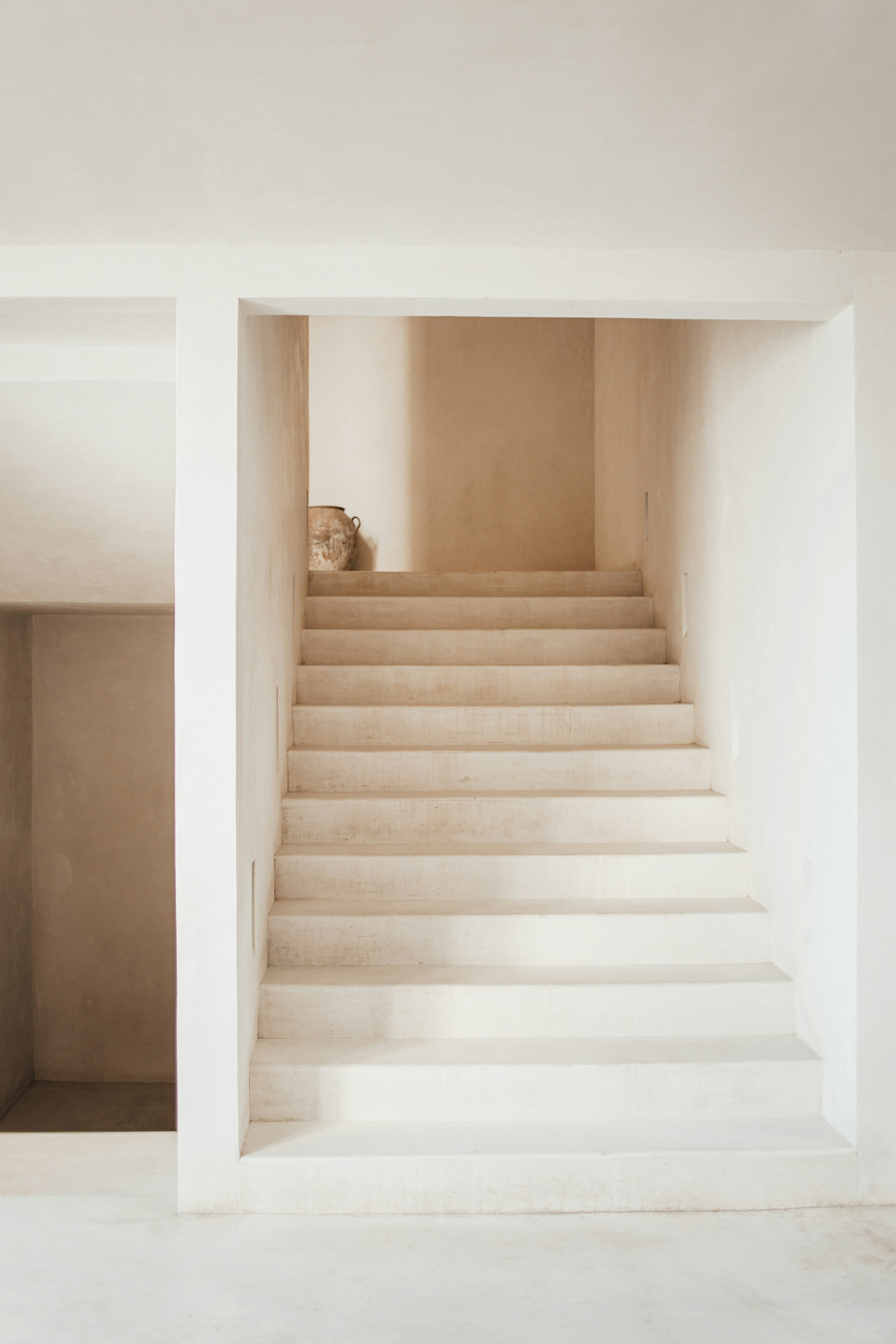Plaster staircase with an antique vase